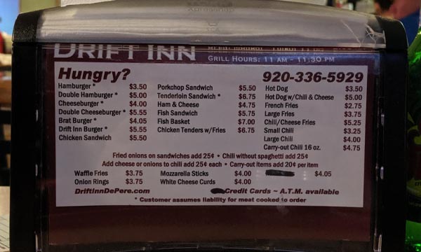 Drift Inn napkin holder showing menu items and prices.